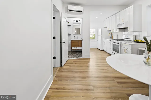 a kitchen with stainless steel appliances kitchen island granite countertop a sink a microwave dining table and chairs