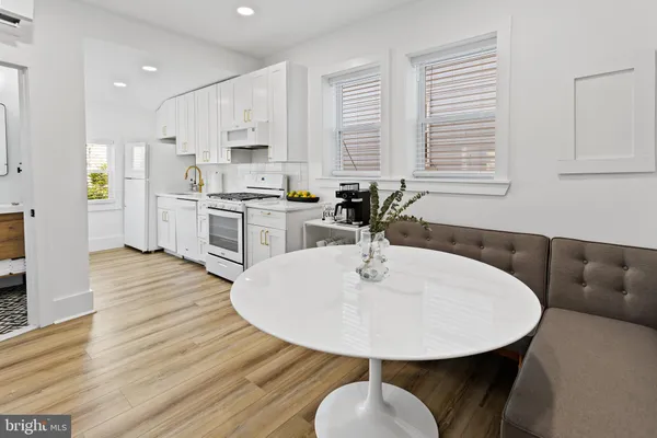 a dining room with furniture and wooden floor
