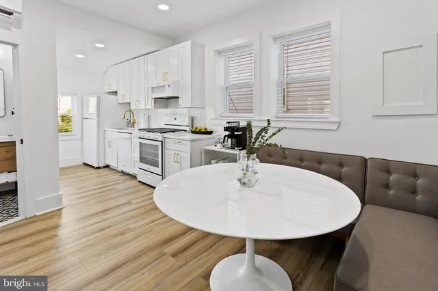 a dining room with furniture and wooden floor