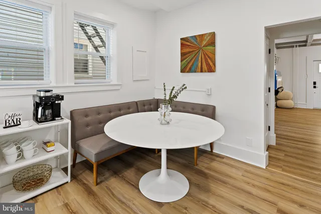 a kitchen with a sink cabinets and wooden floor