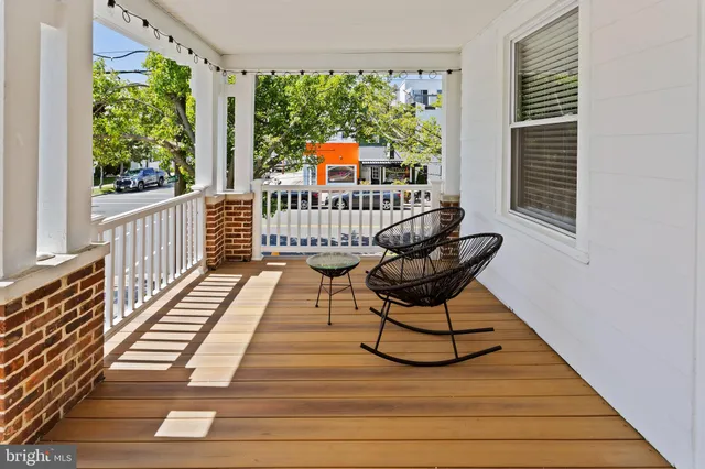 a view of a chair and tables in the balcony