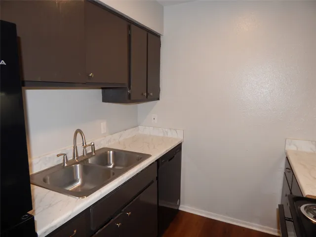 a kitchen with a sink and cabinets