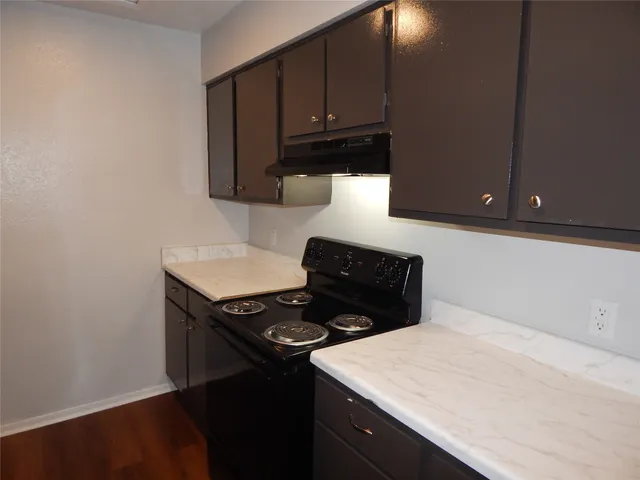 a kitchen with a stove and a microwave