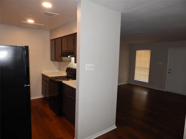 a kitchen with a sink and a refrigerator