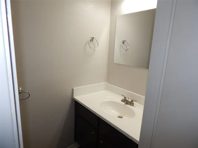a bathroom with a sink and mirror