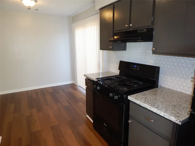 a stove top oven sitting inside of a kitchen