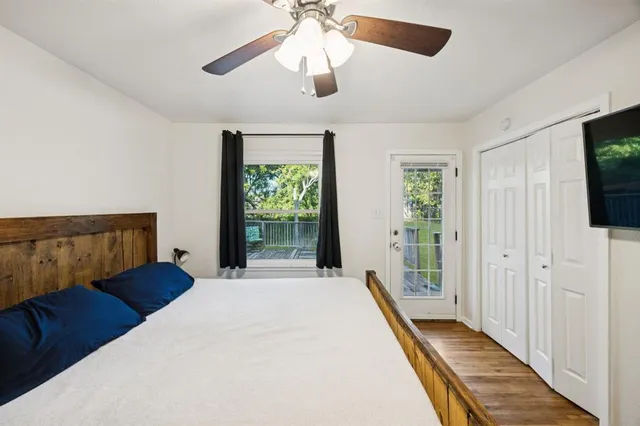 a bedroom with a bed and a flat tv screen