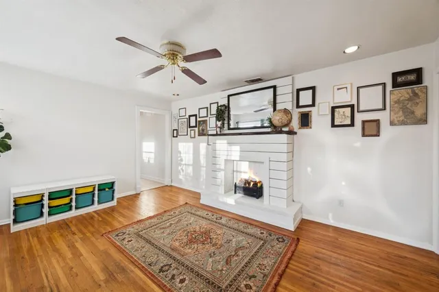 a living room with stainless steel appliances kitchen island granite countertop furniture and a rug