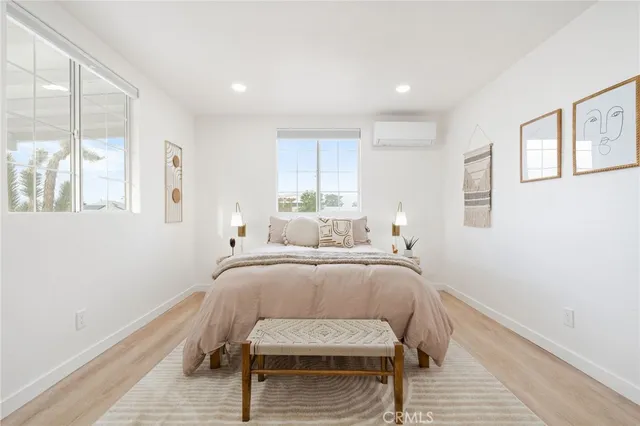 a bedroom with a bed and wooden floor