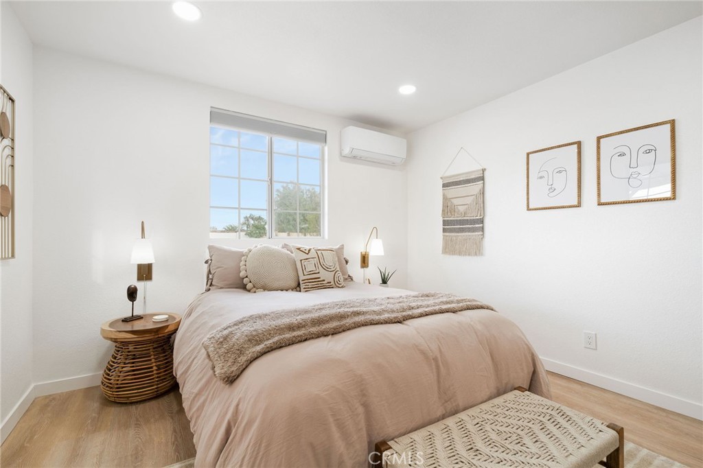 62046 Mountain View Circle Joshua Tree, CA 92252 - Photo 20 of 69 a bedroom with a bed and wooden floor