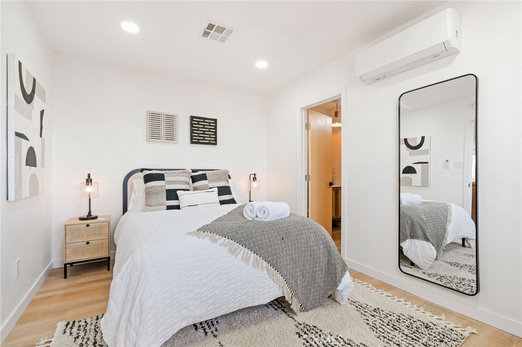 62046 Mountain View Circle Joshua Tree, CA 92252 - Photo 22 of 69 a bedroom with a bed and a mirror