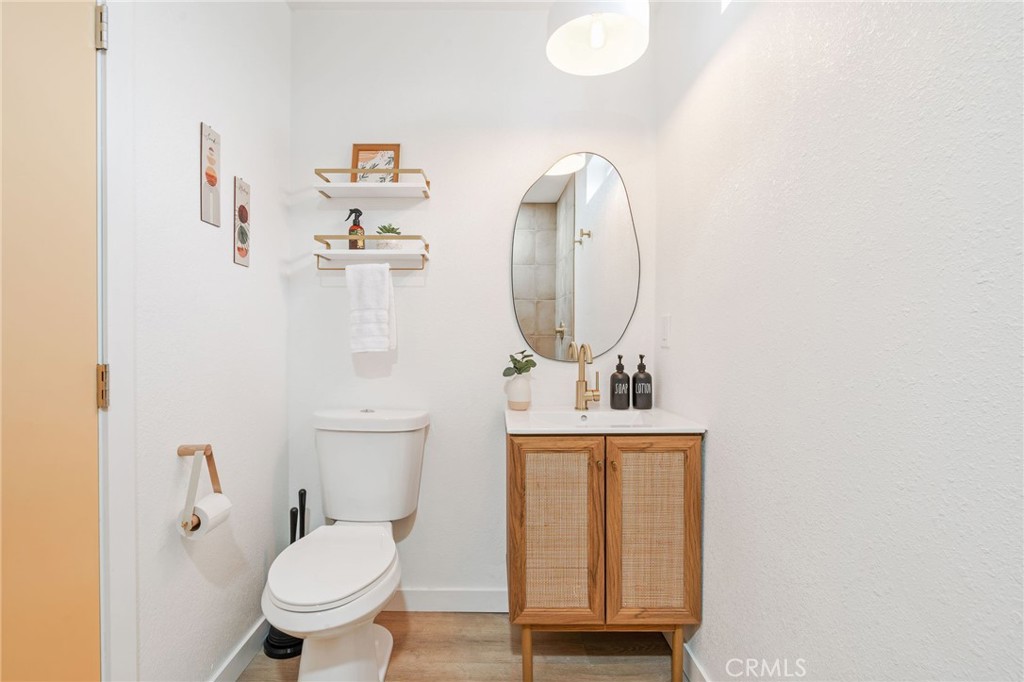 62046 Mountain View Circle Joshua Tree, CA 92252 - Photo 26 of 69 a bathroom with a toilet a sink and mirror