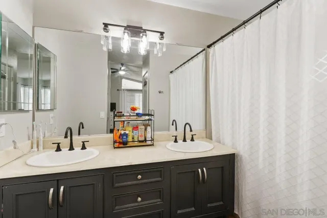 a bathroom with a double vanity sink and mirror