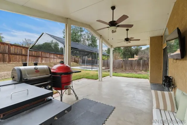 a living room with couch tv and a floor to ceiling window