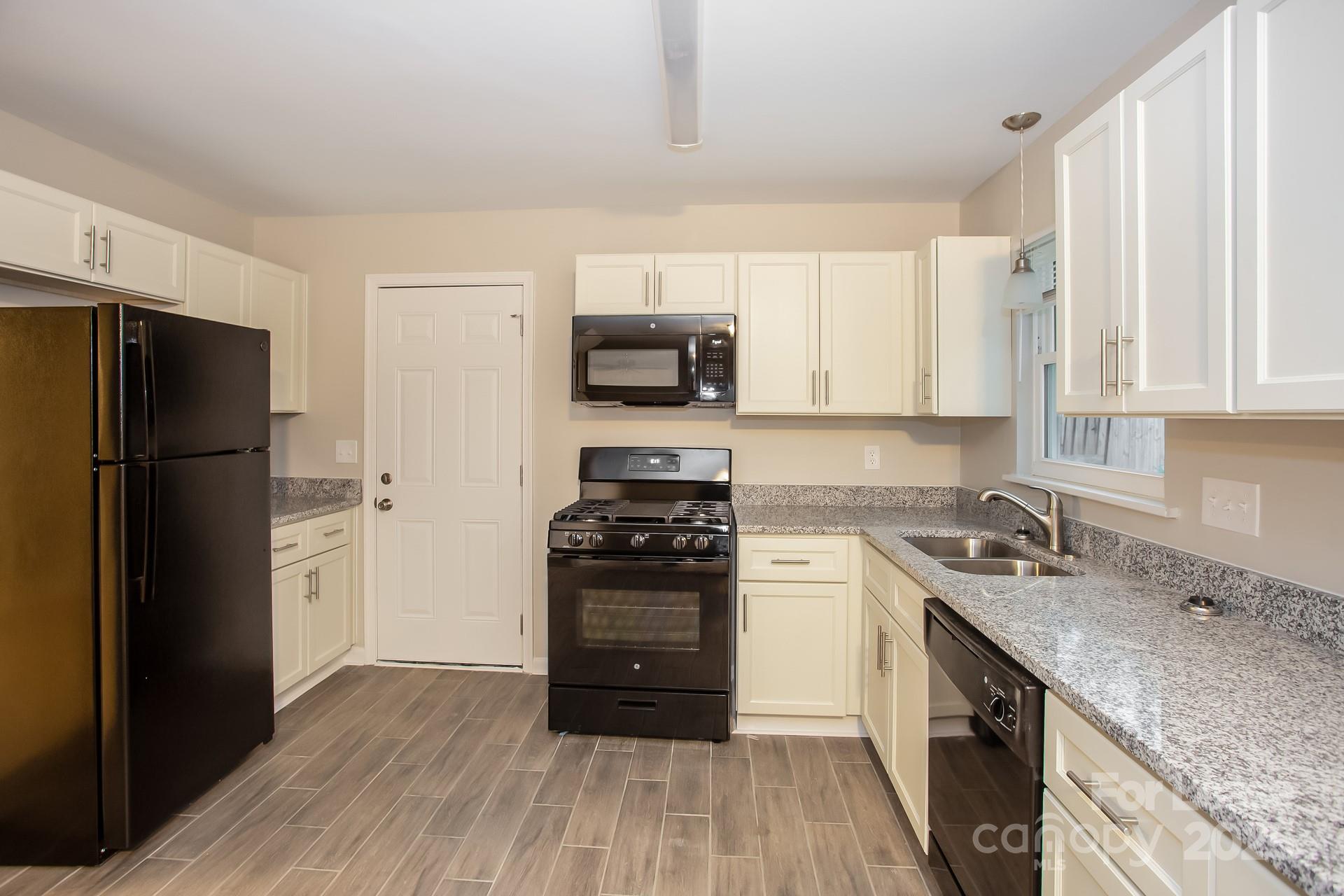 10321 Roundhouse Circle Mint Hill, NC 28227 - Photo 5 of 17 a kitchen with a refrigerator stove and sink