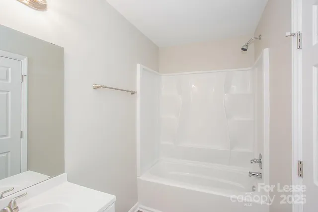 a bathroom with a bathtub and a toilet
