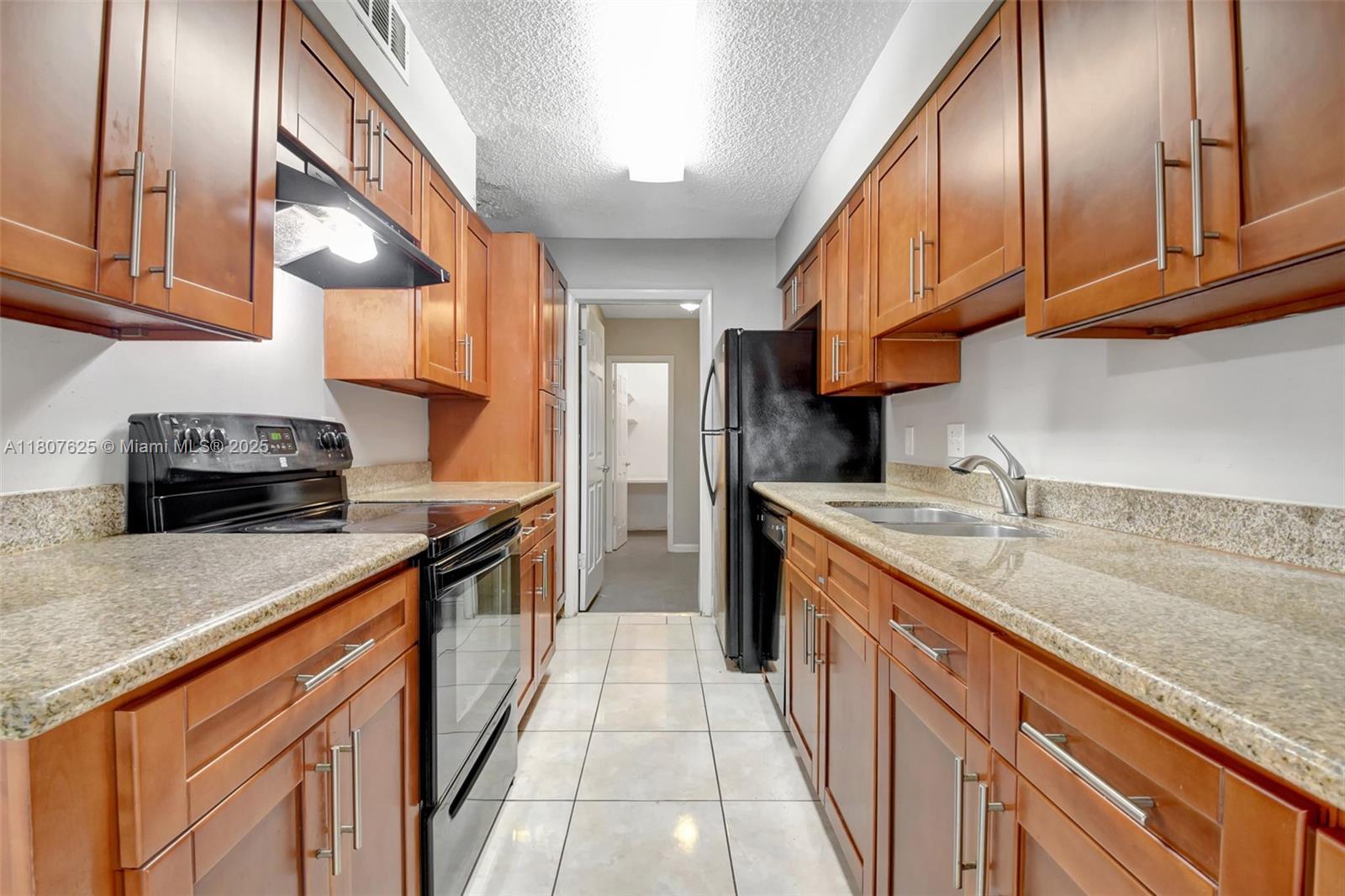 6160 Camp Lee Road West Palm Beach, FL 33417 - Photo 12 of 42 a kitchen with stainless steel appliances granite countertop a sink a stove and a wooden floors