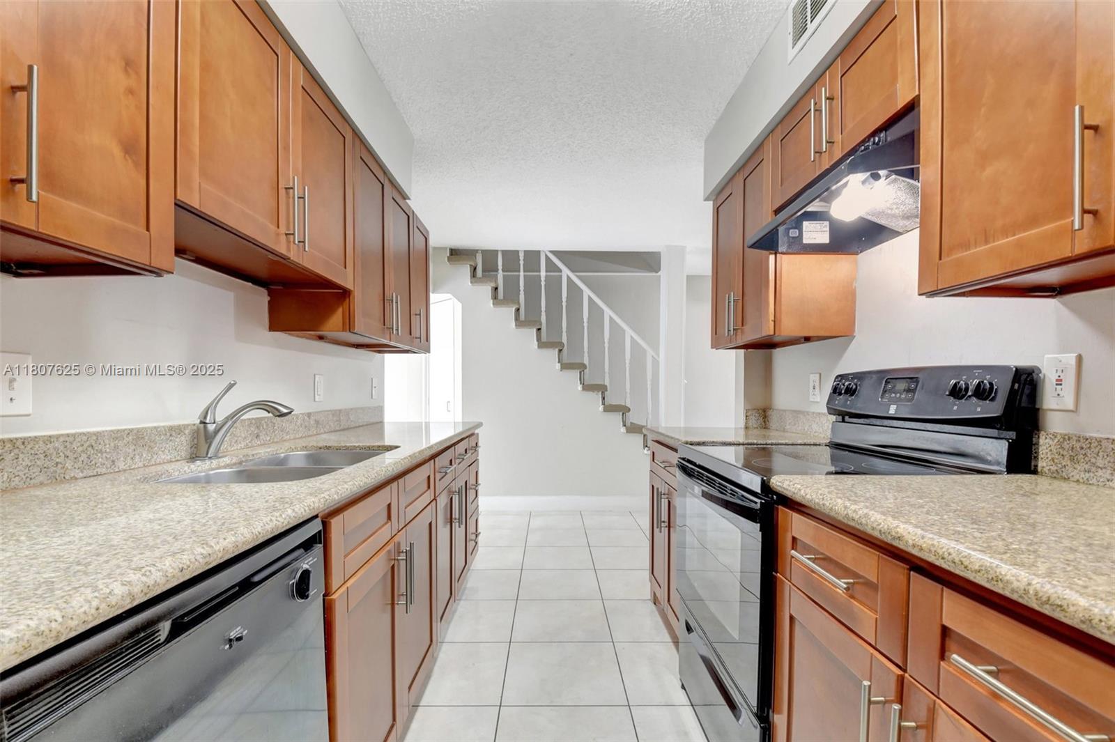 6160 Camp Lee Road West Palm Beach, FL 33417 - Photo 13 of 42 a kitchen with granite countertop a sink a stove and cabinets