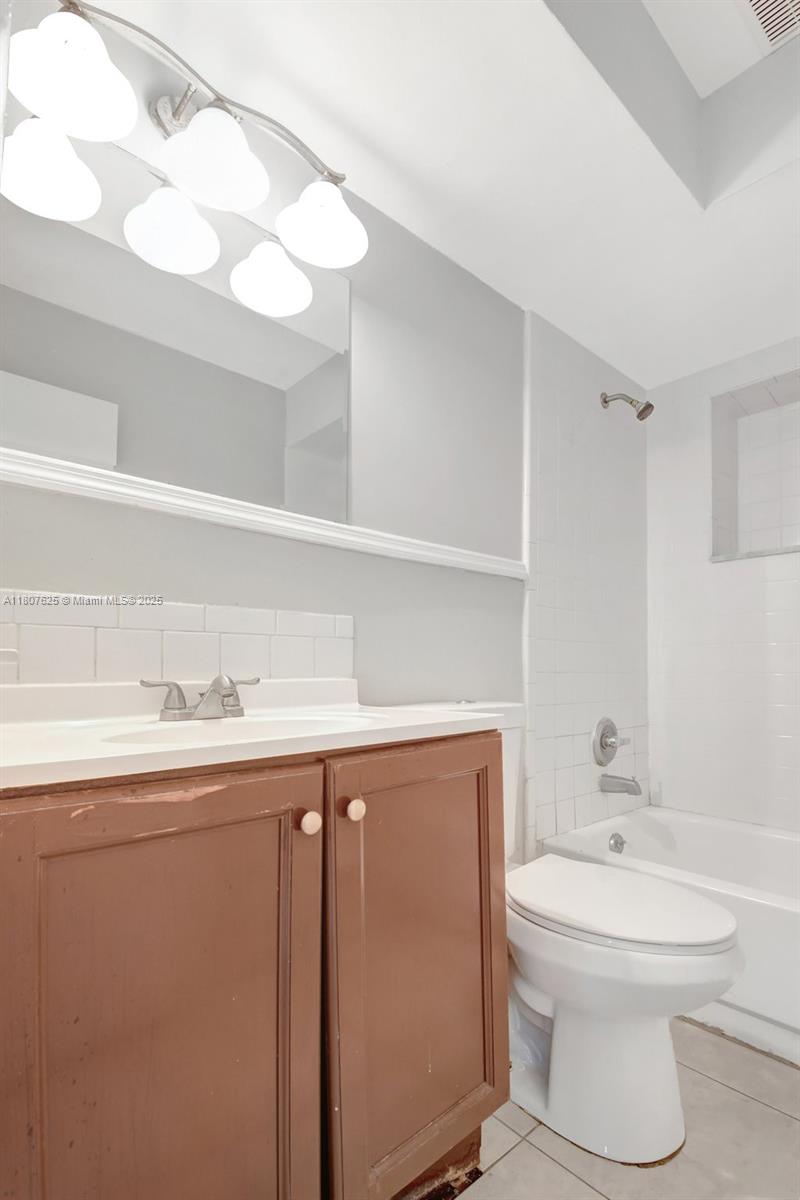 6160 Camp Lee Road West Palm Beach, FL 33417 - Photo 19 of 42 a bathroom with a toilet sink a mirror and vanity