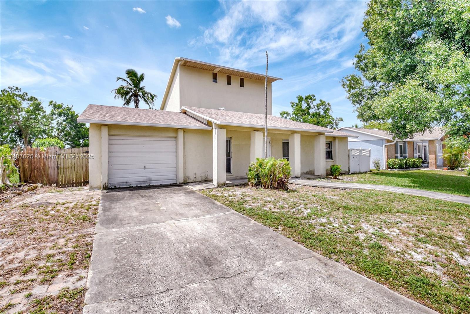 6160 Camp Lee Road West Palm Beach, FL 33417 - Photo 2 of 42 a front view of a house with a yard and garage