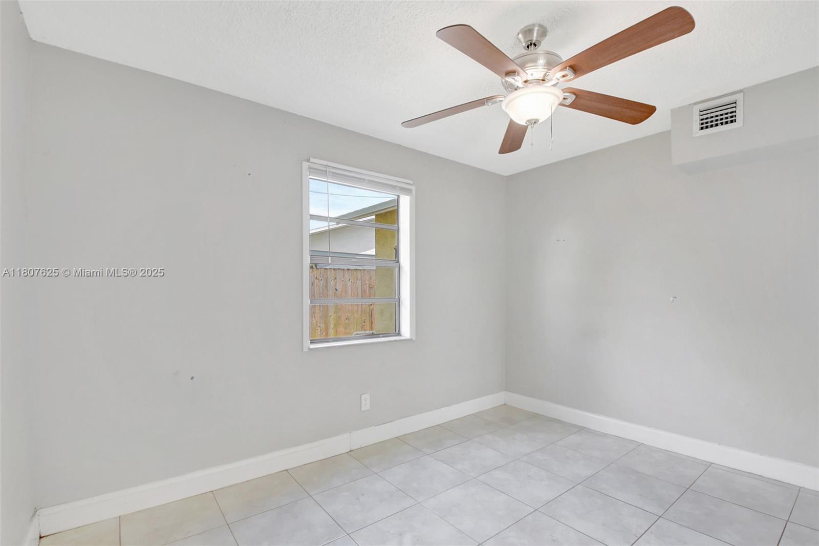6160 Camp Lee Road West Palm Beach, FL 33417 - Photo 22 of 42 an empty room with ceiling fan and window
