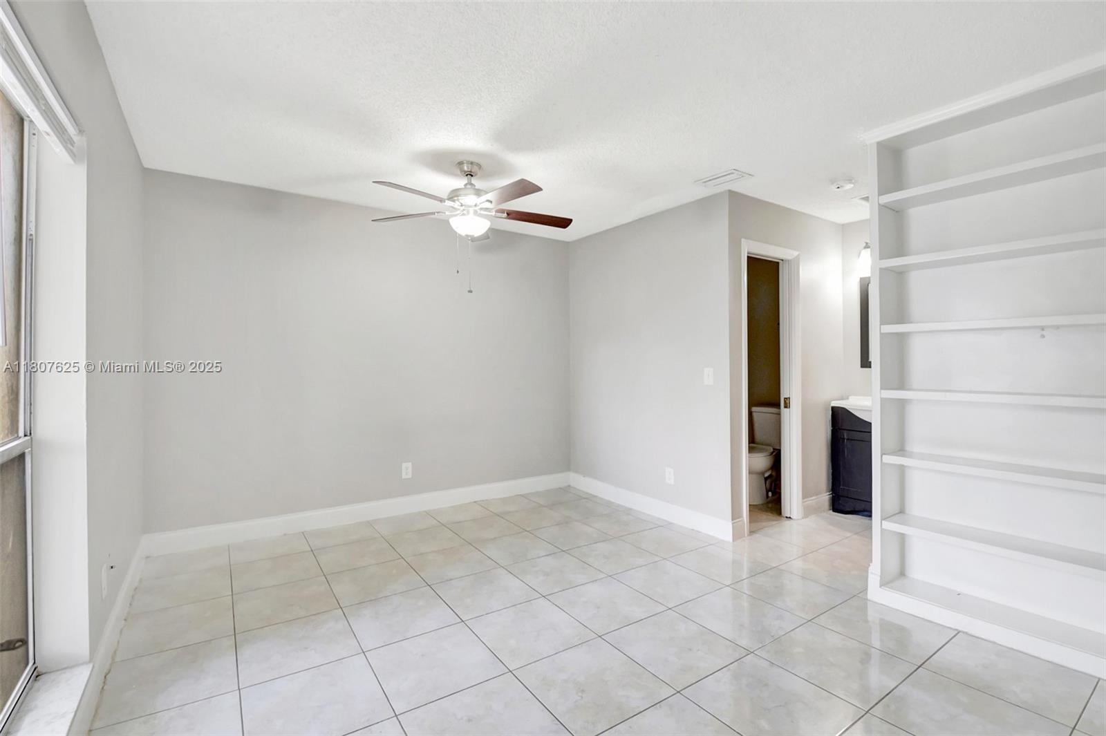 6160 Camp Lee Road West Palm Beach, FL 33417 - Photo 24 of 42 an empty room with closet and a ceiling fan