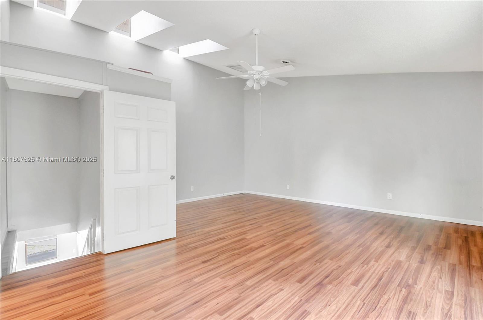 6160 Camp Lee Road West Palm Beach, FL 33417 - Photo 29 of 42 an empty room with wooden floor and windows