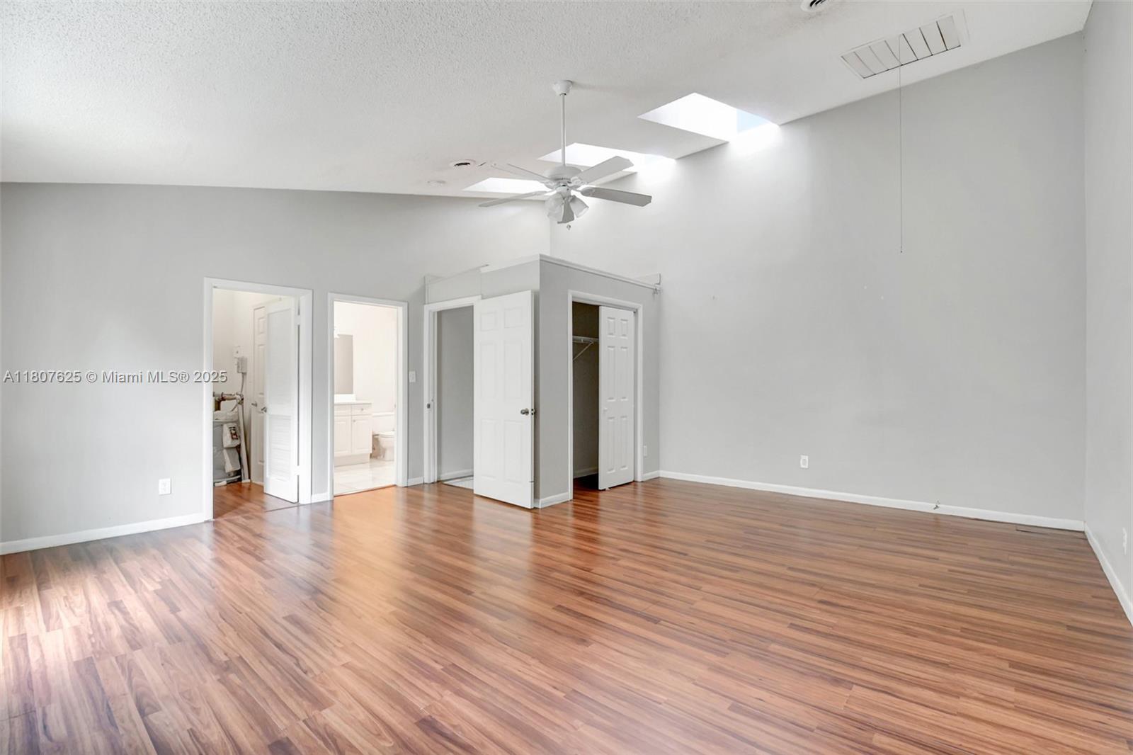 6160 Camp Lee Road West Palm Beach, FL 33417 - Photo 30 of 42 a view of an empty room with wooden floor and a ceiling fan