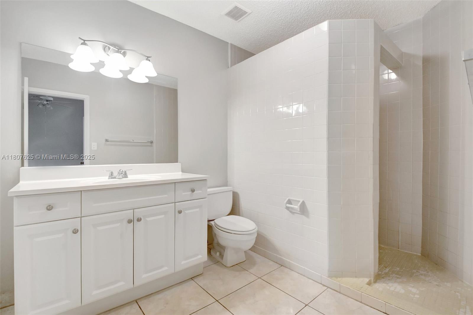 6160 Camp Lee Road West Palm Beach, FL 33417 - Photo 32 of 42 a bathroom with a toilet sink and mirror