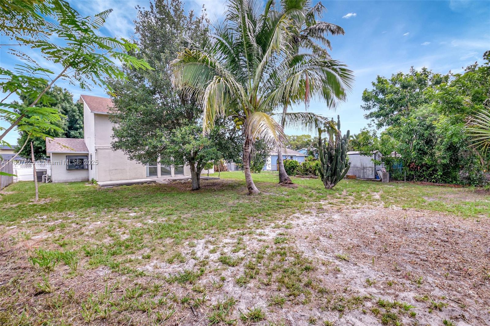 6160 Camp Lee Road West Palm Beach, FL 33417 - Photo 39 of 42 a view of a yard with palm trees