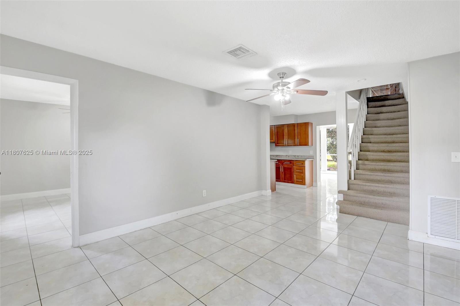 6160 Camp Lee Road West Palm Beach, FL 33417 - Photo 6 of 42 a view of an empty room with a ceiling fan and a window