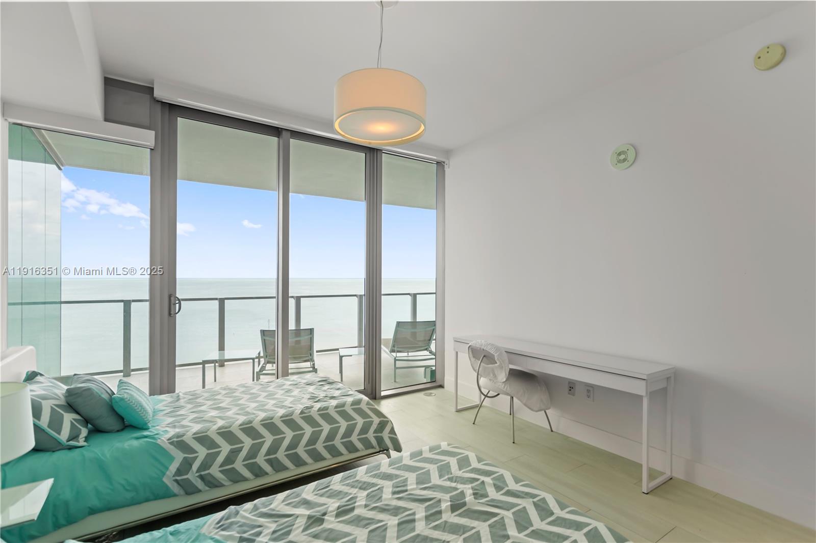 350 Ocean Drive, Unit 904N Key Biscayne, FL 33149 - Photo 27 of 40 a living room with a bed and a large window