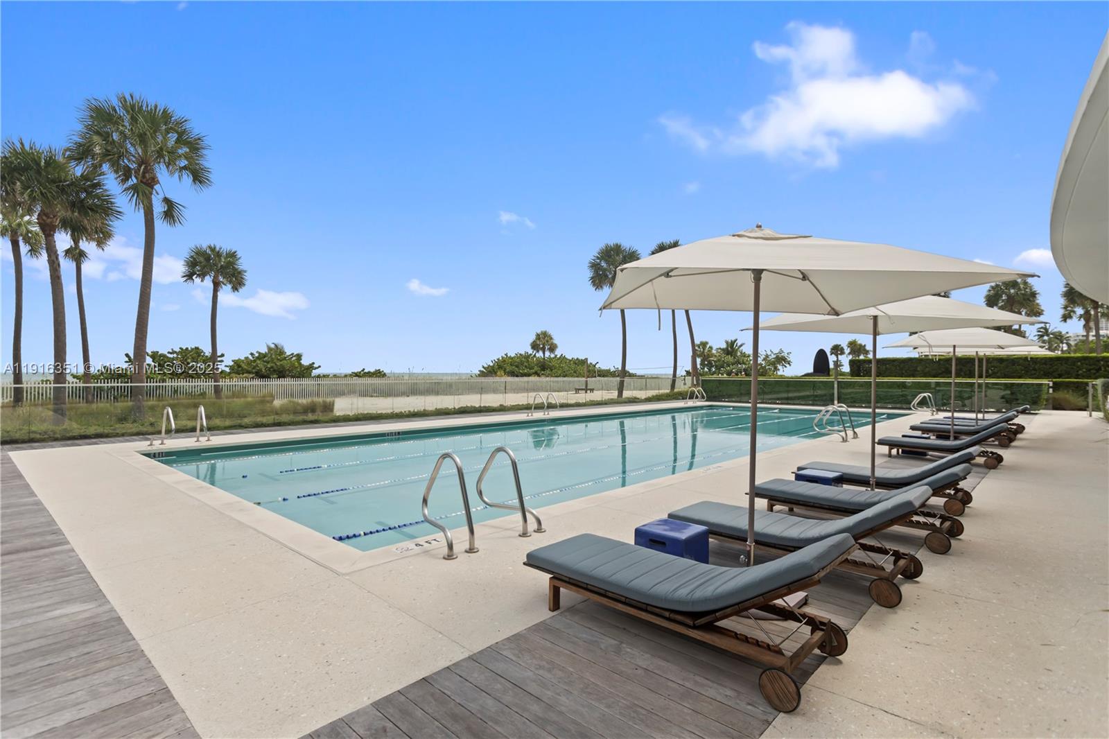 350 Ocean Drive, Unit 904N Key Biscayne, FL 33149 - Photo 39 of 40 a view of a swimming pool with lounge chairs