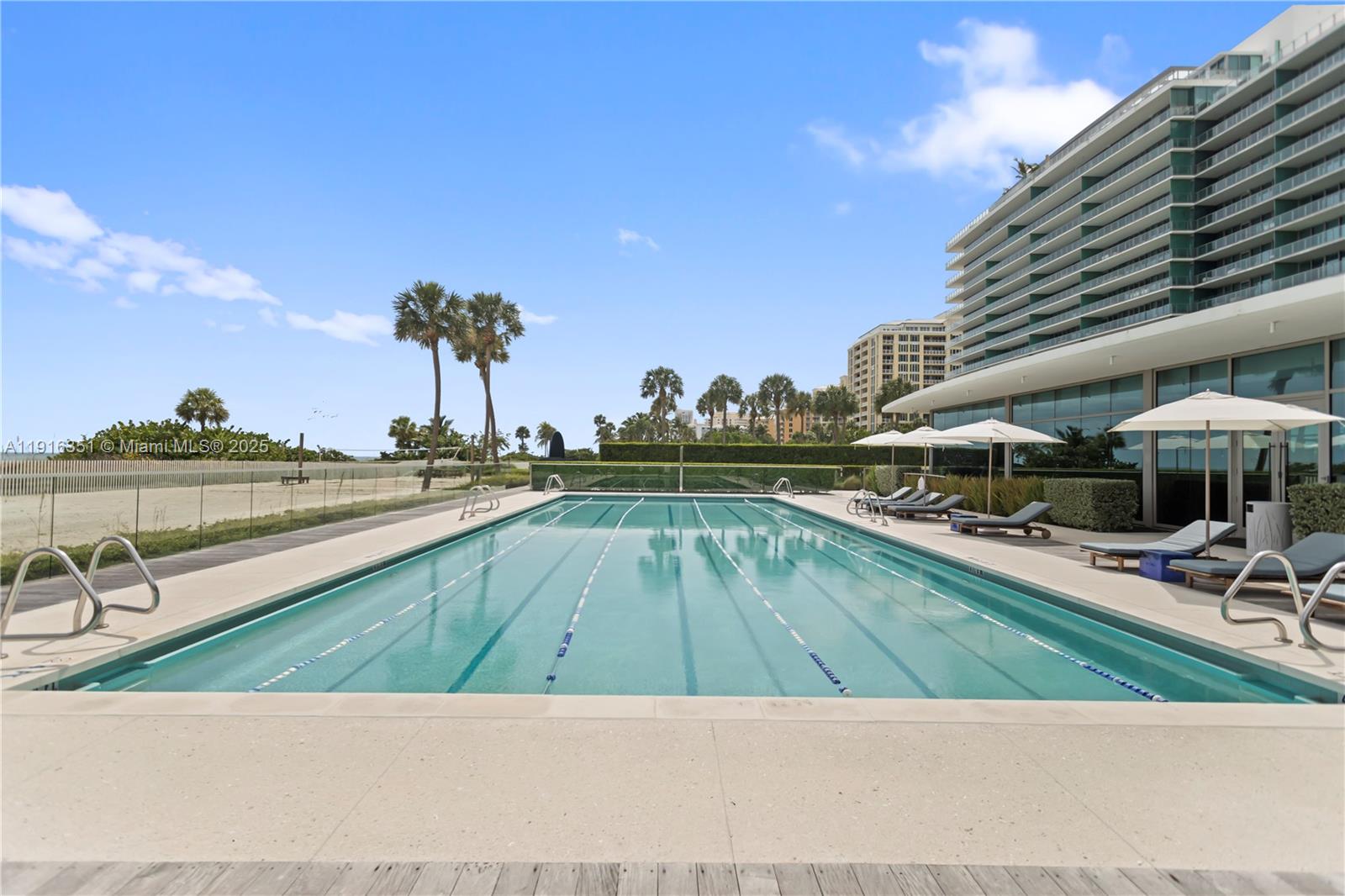 350 Ocean Drive, Unit 904N Key Biscayne, FL 33149 - Photo 40 of 40 a view of swimming pool with outdoor seating and yard in the back