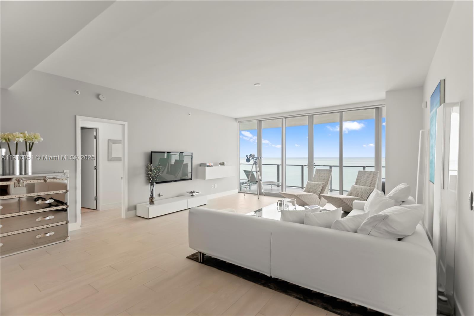 350 Ocean Drive, Unit 904N Key Biscayne, FL 33149 - Photo 6 of 40 a living room with furniture and a flat screen tv