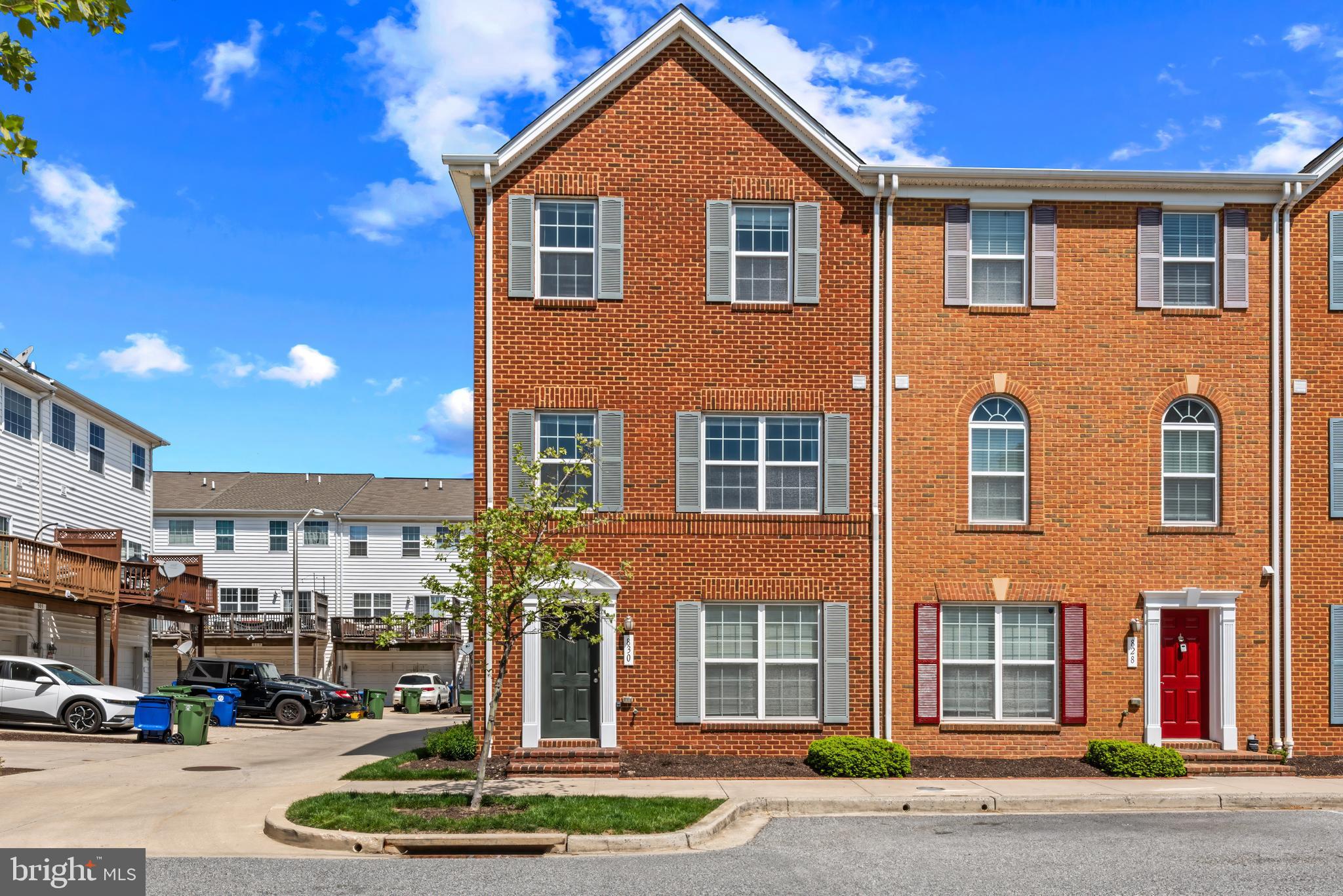 a front view of a residential apartment building with a yard