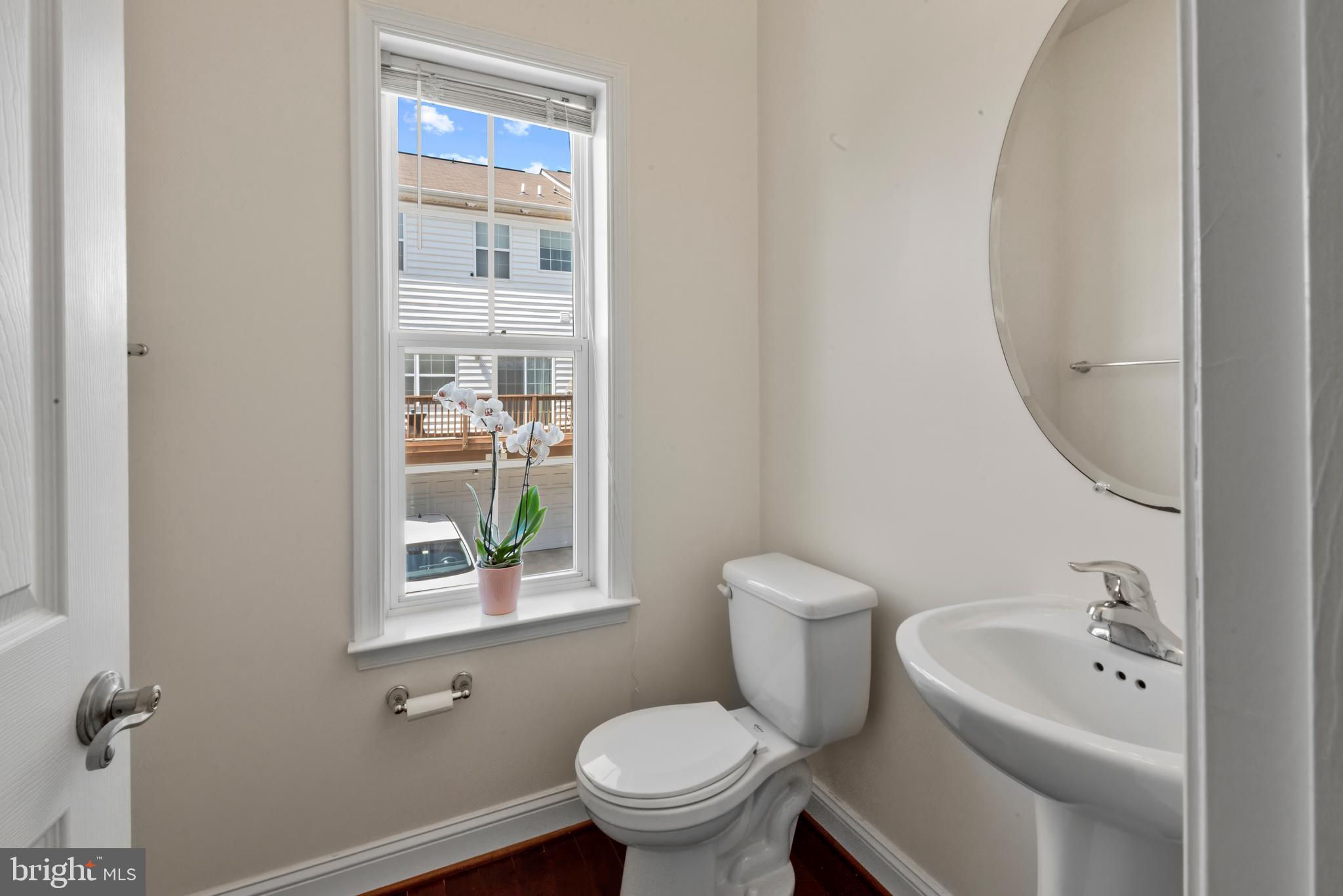 830 Ryan Street Baltimore, MD 21230 - Photo 12 of 24 a bathroom with a toilet sink and mirror