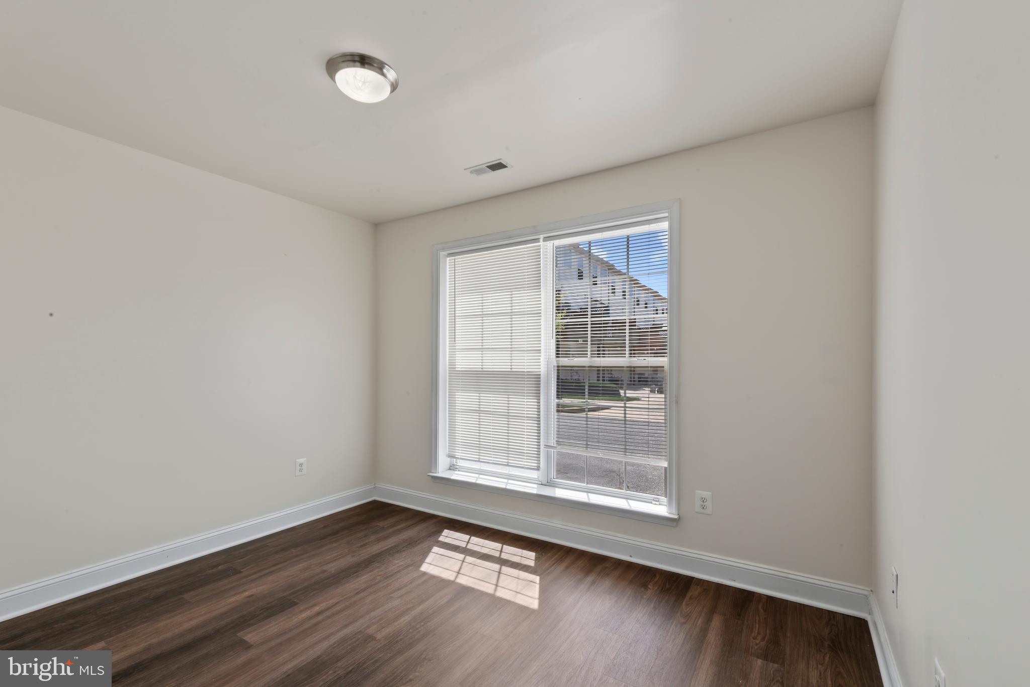 830 Ryan Street Baltimore, MD 21230 - Photo 3 of 24 an empty room with wooden floor and windows