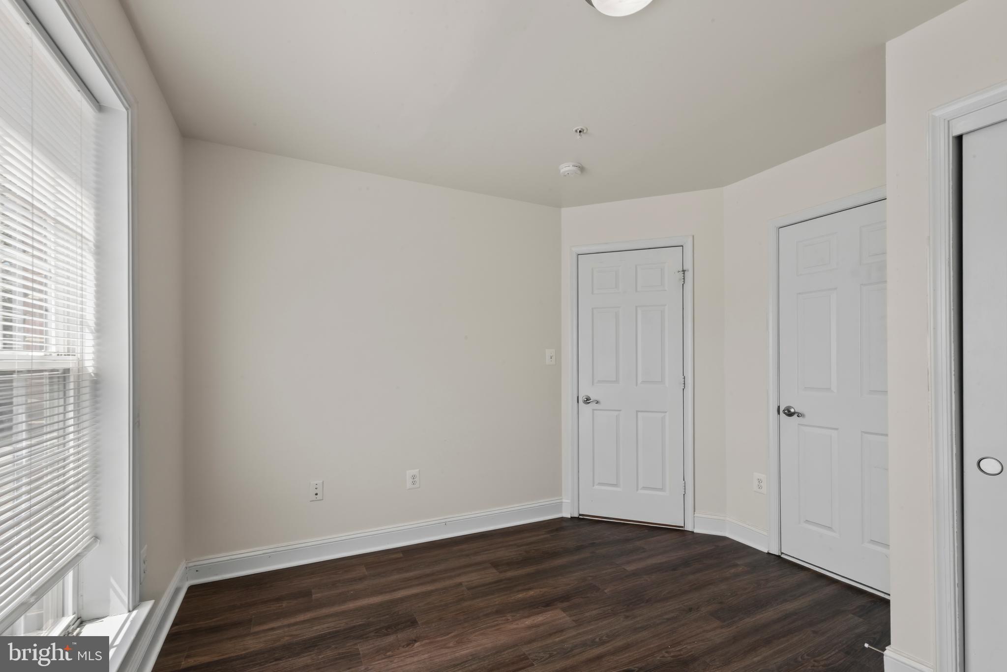 830 Ryan Street Baltimore, MD 21230 - Photo 4 of 24 a view of an empty room with wooden floor and a window