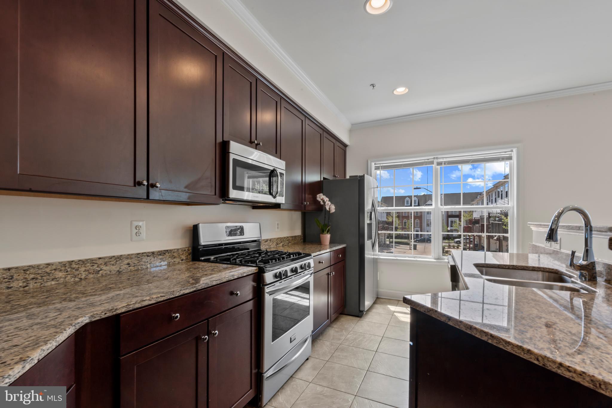 830 Ryan Street Baltimore, MD 21230 - Photo 8 of 24 a kitchen with stainless steel appliances granite countertop a sink stove and cabinets