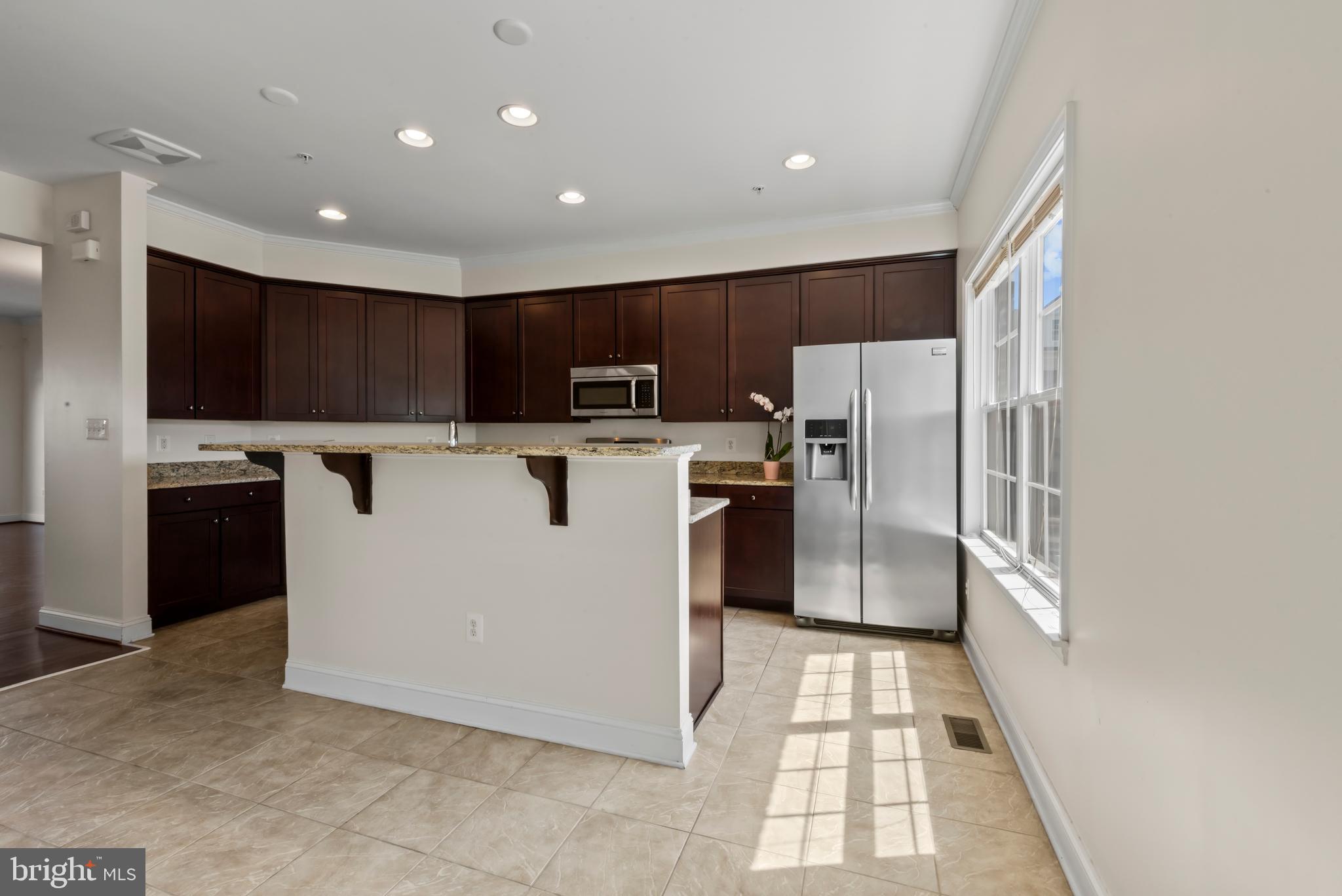 830 Ryan Street Baltimore, MD 21230 - Photo 9 of 24 a kitchen with stainless steel appliances granite countertop a refrigerator a stove a sink and a microwave