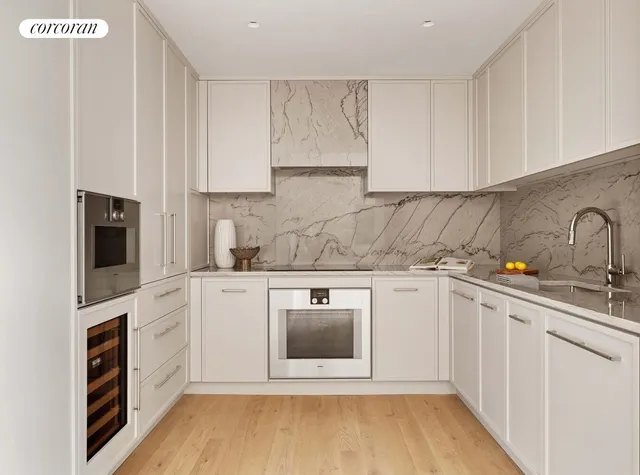 a kitchen with a table chairs refrigerator and cabinets