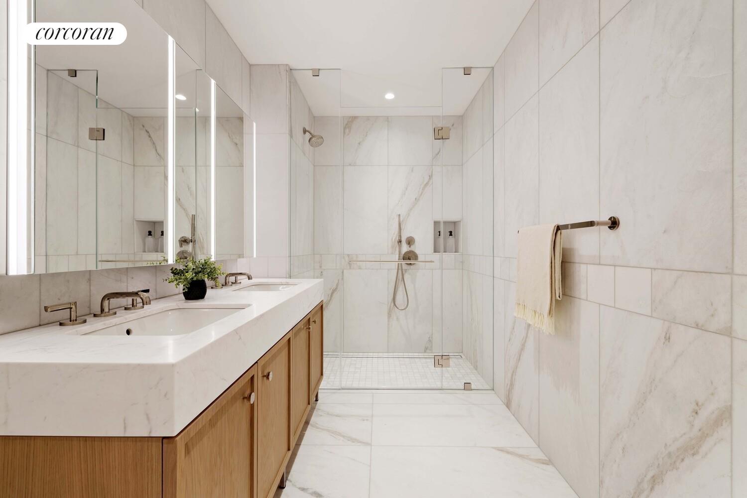 181 MacDougal Street, Unit 4A Manhattan, NY 10011 - Photo 8 of 17 a bathroom with a double vanity sink a large mirror and shower