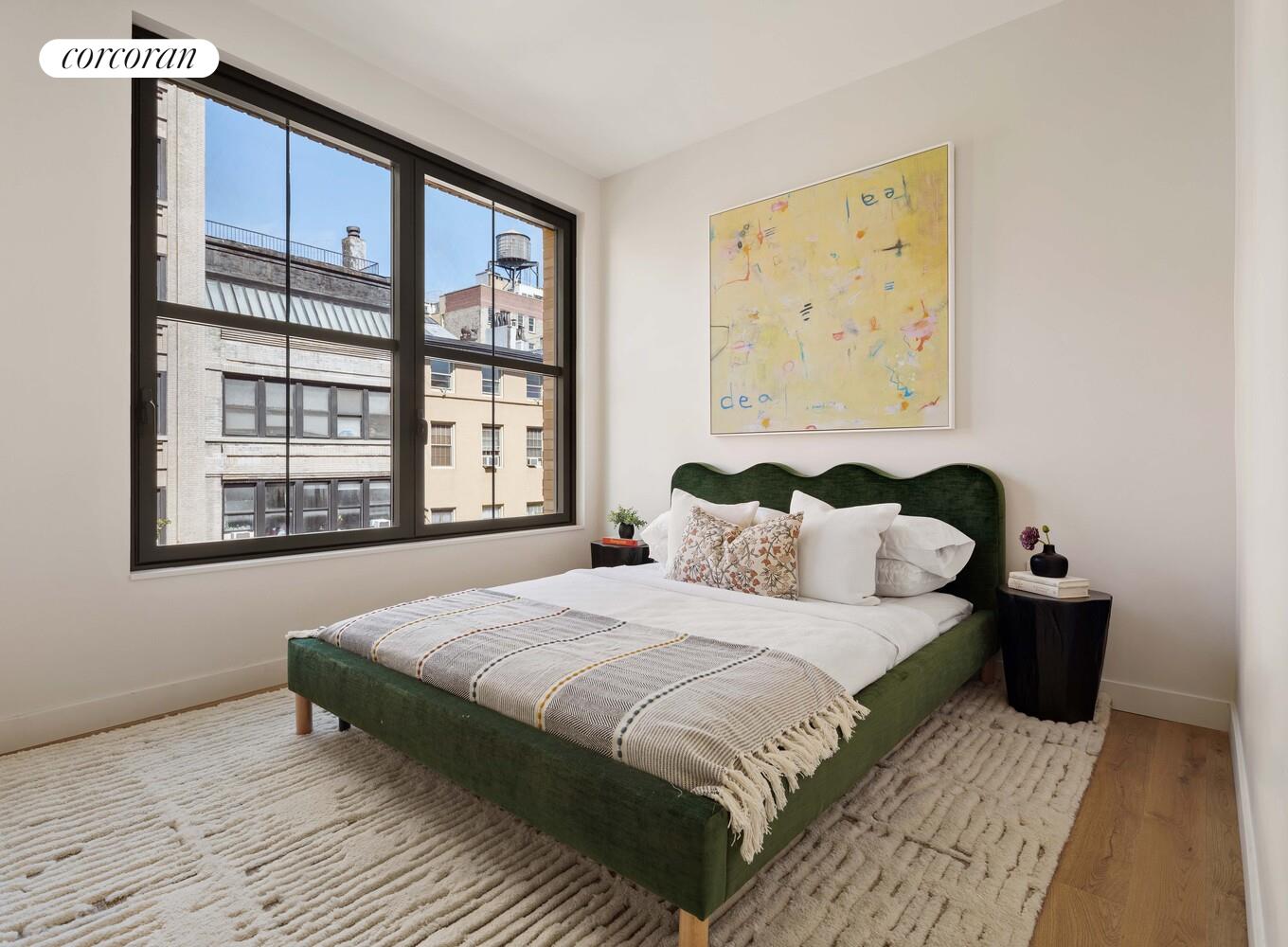 181 MacDougal Street, Unit 4A Manhattan, NY 10011 - Photo 9 of 17 a bedroom with a bed and a large window