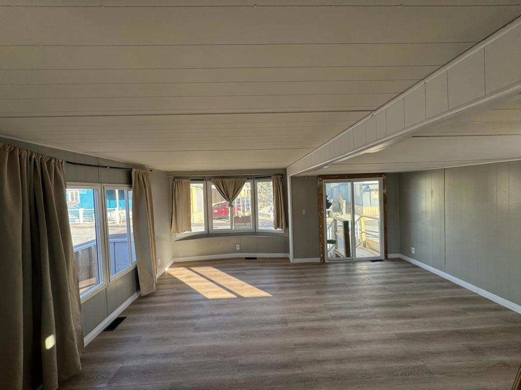 66455 Dillion Road, Unit 43 Desert Hot Springs, CA 92241 - Photo 3 of 8 a view of empty room with wooden floor and fan