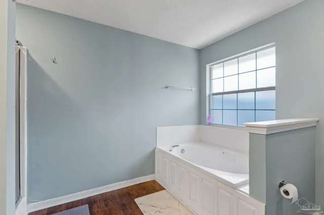 a bathroom with a bathtub and window