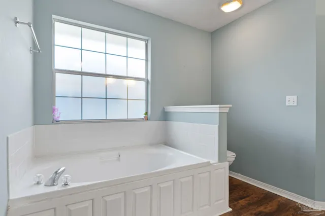 a white bath tub sitting next to a window