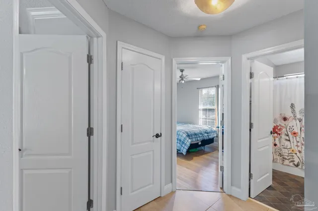 a view of a hallway to room and dining room