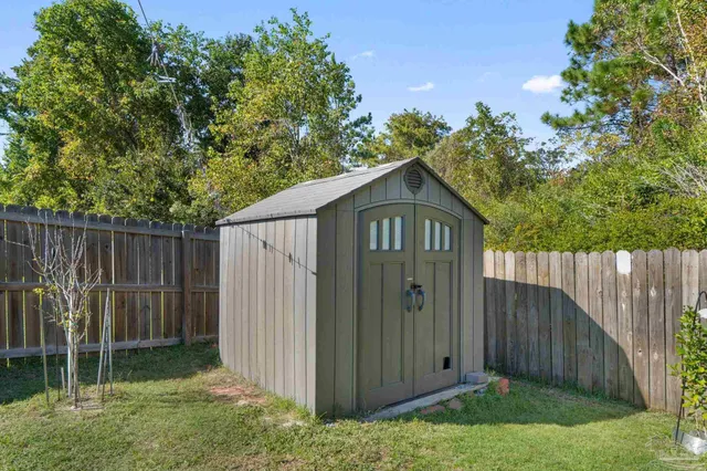 a wooden door in front of a wooden fence