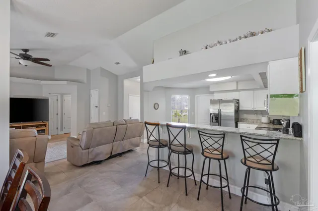 a view of a dining room with furniture and a flat screen tv